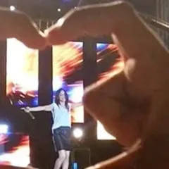 A fan's perspective, making a heart with their hands. Seeing this kind of love from the crowd is what makes it all worthwhile.