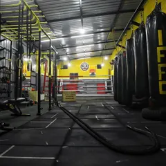 Welcome to the proving grounds. This is where you'll sweat, grind, and transform. Our facility is fully equipped with everything you need to become a warrior, from the boxing ring to the functional training zone with heavy bags and battle ropes.