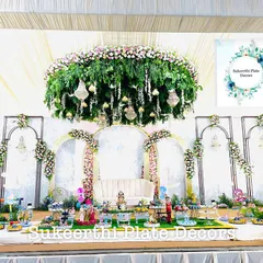 For this grand baby shower, I created a beautiful display in front of an elegant floral stage. The setup includes a variety of decorated platters on German silver stands, all coordinated to create a memorable welcome for the new baby.