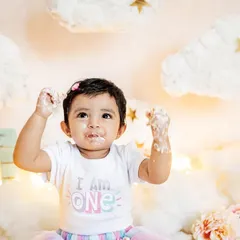 This little one is proud to be one and isn't afraid to get messy. The "I am ONE" shirt and a face full of frosting make for the perfect cake smash photo.