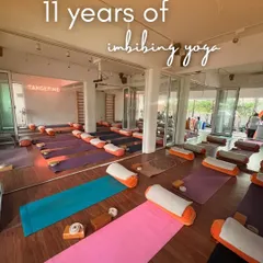 The studio, ready for a class. Each mat is a space for personal discovery, set up with bolsters and blocks to support every student's unique journey.