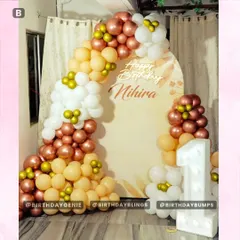 A beautiful bohemian-style first birthday with a muted color palette of rose gold, peach, and white, accented with a light-up number '1'.