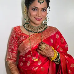 The quintessential bridal look for my beautiful bride Ruchira. Her red Banarasi saree is perfectly complemented by a warm, radiant makeup base, elegant winged eyeliner, and traditional green and gold jewelry.