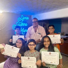 A group of our proud students with their teacher after clearing the Gandharwa Mahavidyalaya exams. We provide complete preparation for these certified music examinations.