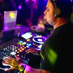 A close-up shot of me working the mixer and decks. Every knob, fader, and button is used to shape the sound and build energy on the dance floor.