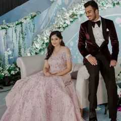 A beautiful stage shot of the couple. The soft makeup and hairstyle perfectly complement the fairytale vibe of her engagement look.