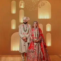A classic wedding portrait is a timeless treasure. Here, we balanced the warmth of the ambient light and the elegance of the decor to create a regal portrait of the couple, highlighting their coordinated outfits and serene connection on their big day.
