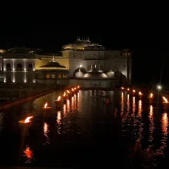 The breathtaking architecture of the Fairmont Jaipur at night, with diyas lighting up the water body. It’s a perfect example of how I highlight a property's unique aesthetic.