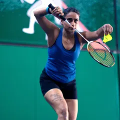 A player in our adult batch focuses on her serve. We provide a supportive environment for adults to learn new skills and refine their technique.