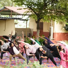 Guiding participants through a side-bending asana to open up the body.