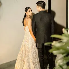 A candid, over-the-shoulder glance that feels intimate and spontaneous. This shot captures a fleeting moment of connection, showcasing the effortless style of the couple.
