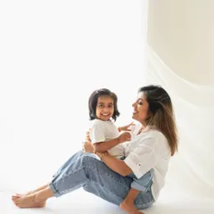 A mother and daughter sharing a laugh in the studio. These are the candid, joyful moments that make for the best family photos.