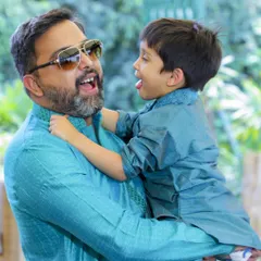 A playful, unposed photograph of a father and son sharing a laugh. My goal is to capture these genuine interactions that truly represent your family's unique personality and bond.