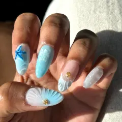 A close-up of my Goa-inspired beach nails. You can see the texture of the 3D shell, the sculpted starfish, and the tiny gold stud details that bring the ocean theme to life.