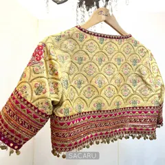 The back view of the multi-patterned blouse, showcasing the beautiful scalloped floral quilting and the intricately detailed sleeves. The combination of colors and textures makes this a standout piece.