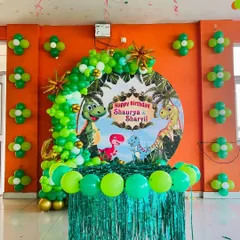 We bring kids' party themes to life with vibrant, detailed decorations. This jungle-themed birthday features a custom dinosaur backdrop, a lush green balloon arch, and matching balloon clusters to create an exciting atmosphere for the little ones.