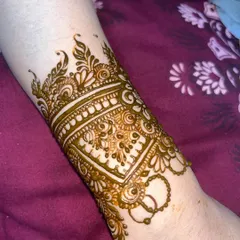 A detailed wristband or `bail` design, perfect for someone who wants an elegant touch without full coverage.