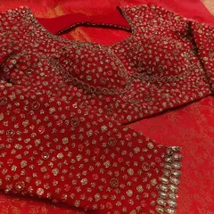 For her grand reception, I designed this deep red blouse for my bride Nayana Gowda. It is fully hand-embroidered with intricate stonework and shimmering sequins, crafted to radiate luxury and complement her reception saree perfectly.