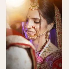 A quiet, intimate moment between the bride and groom on their wedding day. I focus on capturing these gentle expressions and the intricate details of the bridal attire, like her beautiful nath and delicate smile.