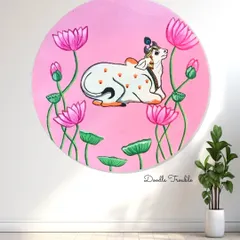 A clean shot of my finished Pichwai-style painting on a wooden round. The vibrant pink background makes the sacred cow and lotus details stand out, ready to become a serene centerpiece on any wall.