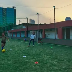 Young players enjoying a dribbling exercise at our free camp. We create a positive environment where kids can have fun while learning the basics of football.