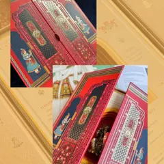 A rich, red boxed invitation with traditional Indian motifs, opening up to reveal the beautiful details inside. This sets the stage for a grand, royal celebration.