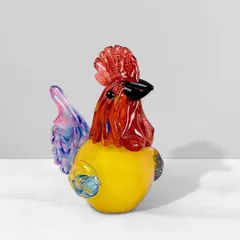This colorful handblown glass rooster is a fun and charming decorative piece. The vibrant mix of red, yellow, and blue makes it a cheerful accent for a kitchen or living room.