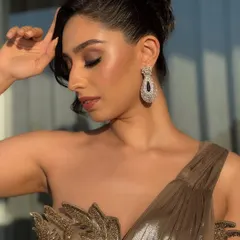 A portrait that captures the sophisticated vibe of the cocktail look. The makeup is sculpted and defined, ensuring it looks stunning in the low light of an evening event.