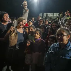 The puppeteers from Brazil's 'Mamulengo de la Mancha' pose for photos with delighted children after the show. The connection between artists and the audience is a vital part of the festival experience we foster.