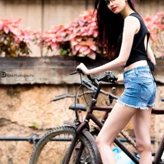 A rustic bicycle and a textured wall add a vintage, old-Bangalore charm to this modern street style photo.