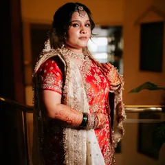 A full-length shot of the bride in her stunning red and white saree, ready for her big day.