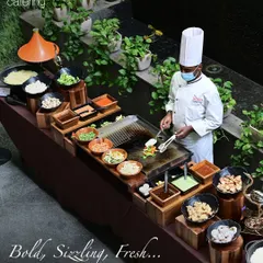 We bring the theatre of Teppanyaki to your party. This high-angle view shows our complete, professional live counter where chefs prepare customized stir-fries with fresh vegetables, proteins, and sauces right before your guests' eyes.