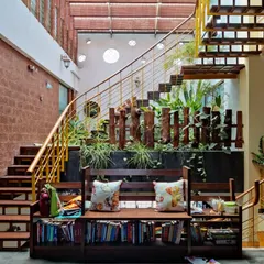 A garden thrives between the flights. This design incorporates a lush indoor garden directly into the staircase structure, bringing life and fresh air into the core of the home and making the journey between floors a refreshing experience.