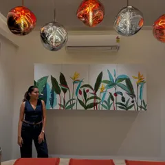 Standing next to the finished tropical mural on the crockery unit. It’s so rewarding to see how it brightens up the entire dining area.