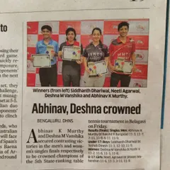 A newspaper clipping from DHNS celebrating the crowning of our players Abhinav K Murthy and Deshna M Vanshika as champions in the men's and women's singles events in Belagavi.