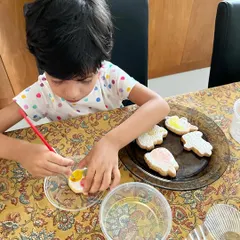 Look at that focus! I love seeing how engaged kids get with their edible art projects. She is carefully painting her cookie using the edible paint palette that comes with every PYO kit.
