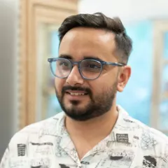 The final result of a great haircut is confidence. This client is all smiles after his transformation, showcasing a modern, clean cut that perfectly suits his style.