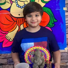 A young artist with his beautifully crafted clay Ganesha. Our workshops provide all the materials and guidance needed for children to create their own festive art, which they can take home for family celebrations.