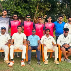 A mix of our players in training gear and match whites pose for a team photo, showcasing the diverse group of cricketers who represent Payyade Sports Club.