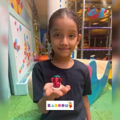 A young artist proudly displays the tiny, detailed Ganesha idol she crafted herself during our festive workshop. It's a wonderful keepsake from a day of creative celebration.