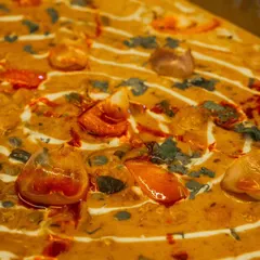 A close-up of a rich and creamy paneer dish, one of the many mouth-watering options available for your team.