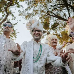 The groom dances with his friends and family during the Baraat procession, a moment of pure joy and celebration.