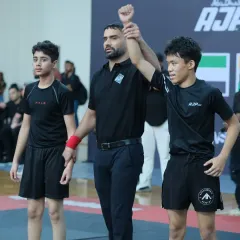 Raising the hand of a winner. As a referee, I get a front-row seat to the incredible skill and heart these young competitors bring to the mat.