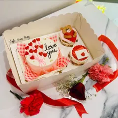 My Valentine's Day bento box is perfect for a sweet surprise. It includes a mini 'love you' cake and two adorable cupcakes, one with a teddy bear and one with a love letter.