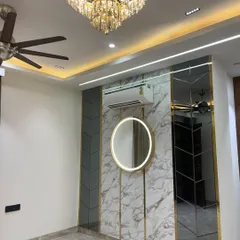 A close-up of the accent wall, showing the beautiful crystal chandelier and the reflection in the mirror panels.