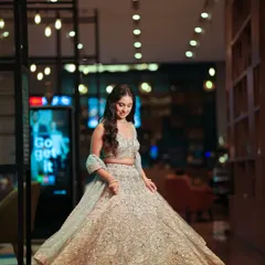 A full-length shot showcasing the bride's gorgeous lehenga. The makeup is perfectly balanced to complement the intricate details of her outfit.