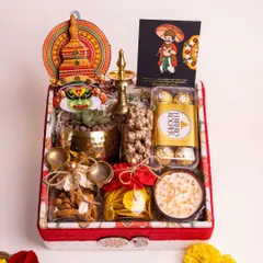 My 'Ponnonam' luxury hamper is a celebration of Onam in a box. It's filled with traditional delights like sharkara varatti and upperi, alongside Ferrero Rocher, a live succulent, and cultural symbols like a Kathakali head and a brass nilavilakku, all presented in a beautifully lined custom box.
