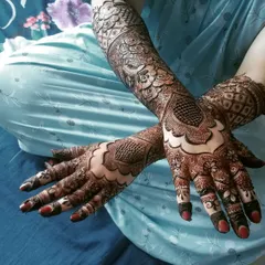 This beautiful engagement henna features a bold geometric pattern on the back of the hands, complemented by intricate details on the fingers and arms.