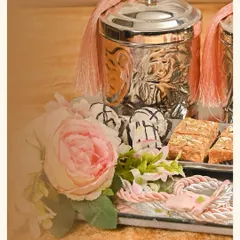 A closer look at the 'Afreen' wedding hamper. I love using elegant silver-plated jars with pink tassels and pairing them with fresh florals and delicious sweets on a mirrored tray.