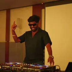 Pointing to the sky and feeling the vibe. A great DJ reads the room and becomes one with the crowd's energy.
